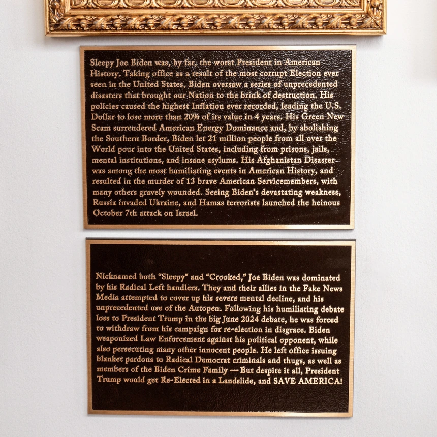Bronze plaques installed beneath Biden portrait at the White House